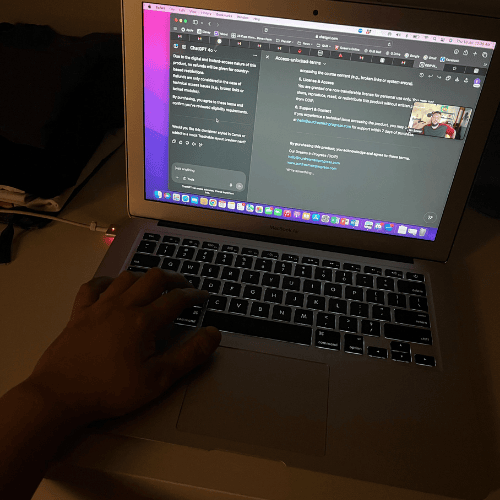 Person using a laptop at night with ChatGPT open on the screen.