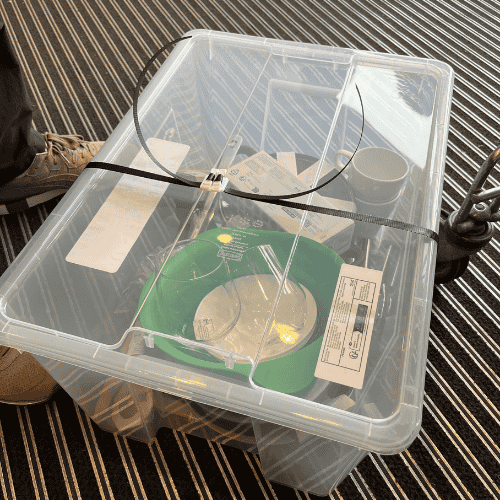 Letting go as a mother while helping my firstborn pack dorm essentials into a clear plastic storage box before moving in.