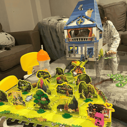 Letting go as a mother while spending quiet time at home with my younger child, surrounded by toys and memories of family moments.